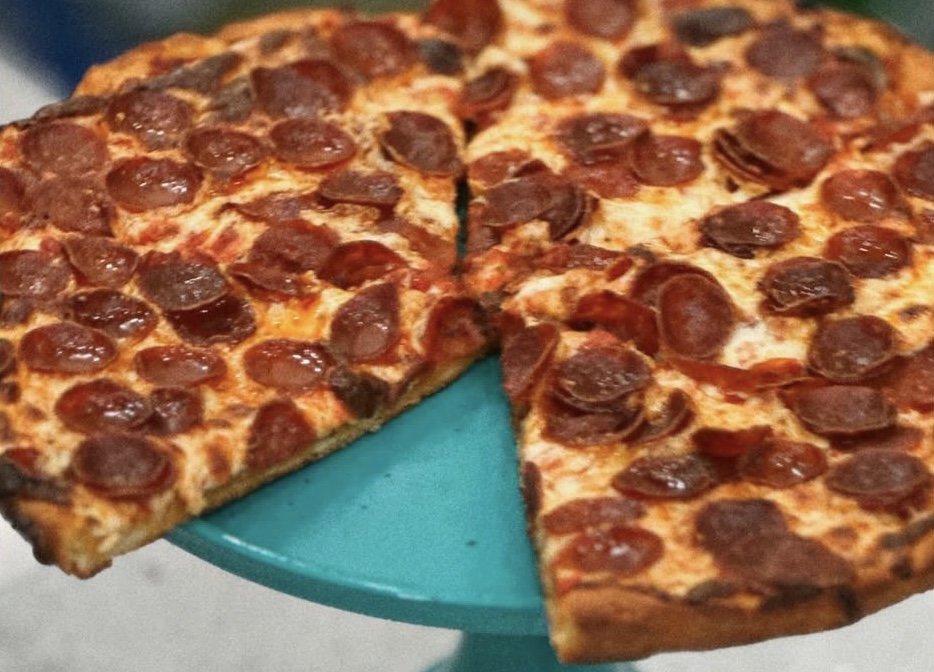 A pepperoni pan pie on a cake stand, a riff on Pizza Hut's original pan